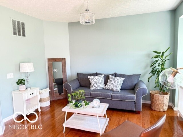 11648 Stickney Ct, Fishers, IN 46037 - living room with wood finished floors, baseboards, and a textured ceiling