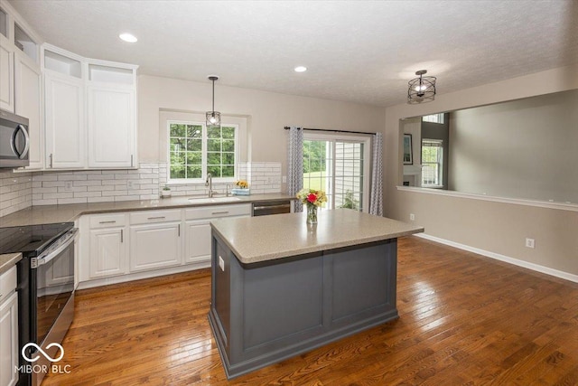 11648 Stickney Ct, Fishers, IN 46037 - kitchen featuring stainless steel appliances, decorative backsplash, a center island, white cabinets, and recessed lighting