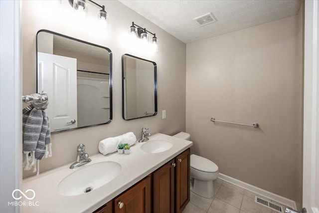 11648 Stickney Ct, Fishers, IN 46037 - full bathroom with toilet, double vanity, tile patterned flooring, baseboards, and a textured ceiling