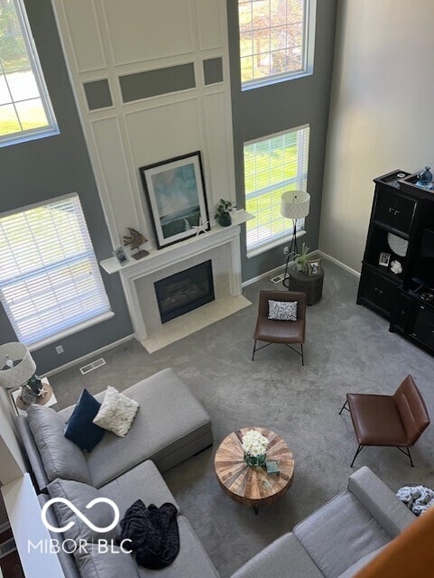 11648 Stickney Ct, Fishers, IN 46037 - carpeted living area featuring a fireplace and baseboards