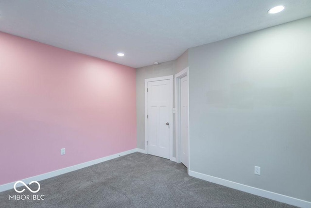 carpeted spare room with baseboards and recessed lighting