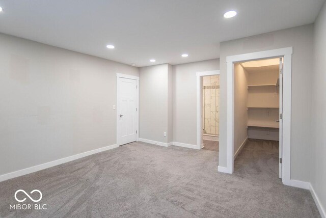 unfurnished bedroom featuring recessed lighting, carpet flooring, and a closet