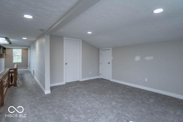 interior space with carpet floors, recessed lighting, baseboards, and a textured ceiling