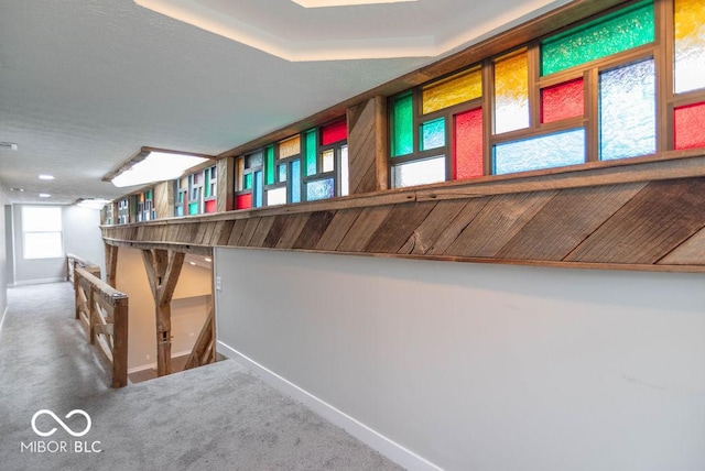 staircase with baseboards and carpet
