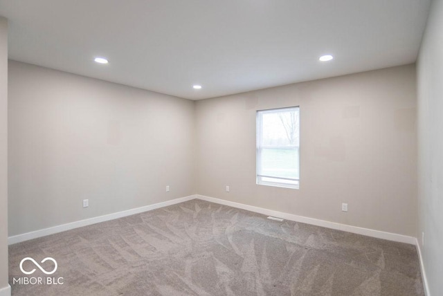 empty room with baseboards, carpet, and recessed lighting