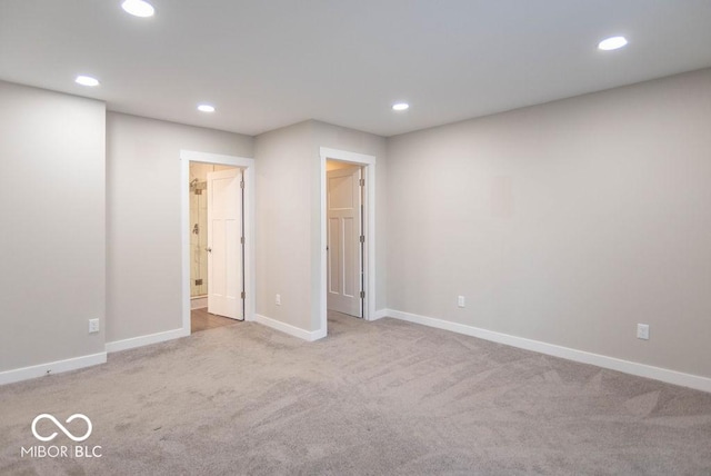 interior space featuring baseboards, carpet, recessed lighting, and ensuite bath