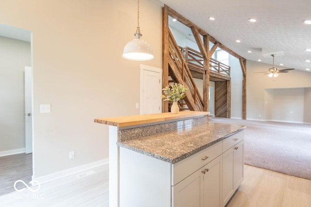 7748 S State Road 39, Clayton, IN 46118 - kitchen with pendant lighting, ceiling fan, high vaulted ceiling, a kitchen island, and white cabinets