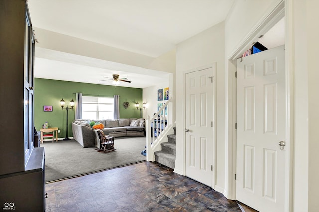 950 Redwood Dr, Franklin, IN 46131 - entryway featuring a ceiling fan, dark carpet, and stairway