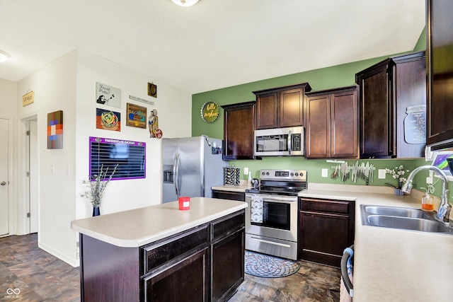 950 Redwood Dr, Franklin, IN 46131 - kitchen featuring appliances with stainless steel finishes, light countertops, a center island, dark brown cabinetry, and stone finish floors