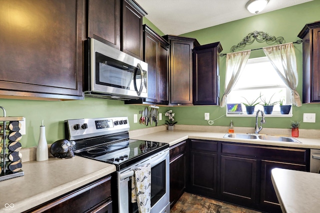 950 Redwood Dr, Franklin, IN 46131 - kitchen featuring stainless steel appliances, light countertops, and dark brown cabinets