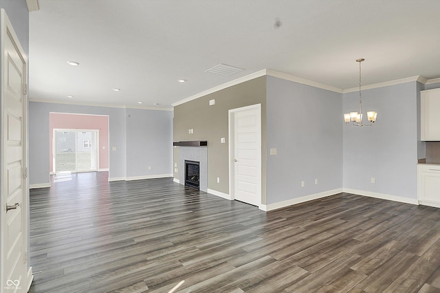 unfurnished living room with baseboards, visible vents, a notable chandelier, a fireplace, and dark wood-type flooring