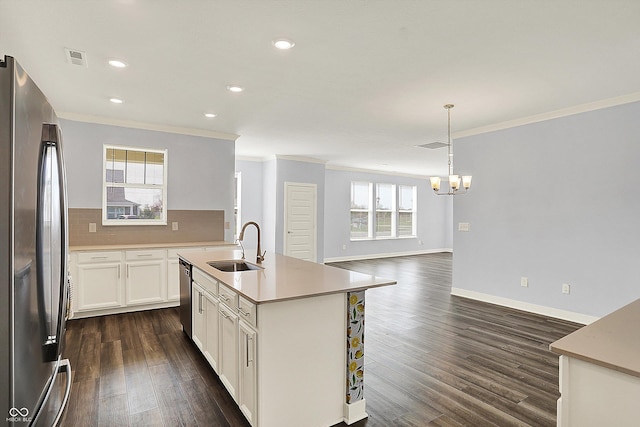 kitchen with a sink, a chandelier, stainless steel appliances, ornamental molding, and dark wood-style floors