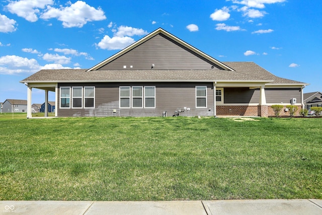 rear view of property with a lawn