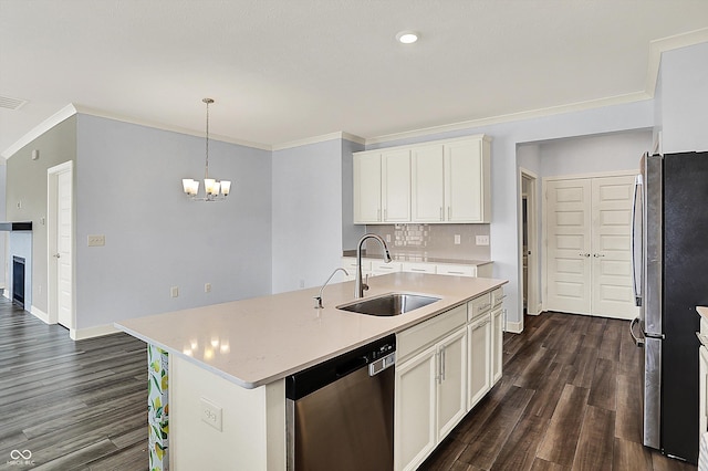 kitchen with appliances with stainless steel finishes, a sink, dark wood-style floors, and light countertops