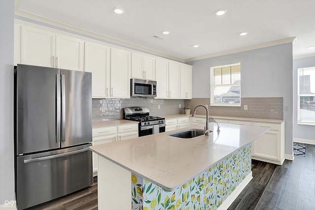 kitchen with dark wood-style flooring, appliances with stainless steel finishes, a sink, and a healthy amount of sunlight