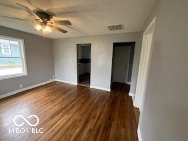 517 Dicks St, Lebanon, IN 46052 - unfurnished room with ceiling fan, visible vents, baseboards, and dark wood finished floors