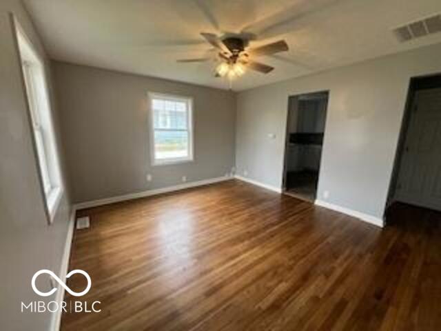 517 Dicks St, Lebanon, IN 46052 - unfurnished bedroom featuring dark wood-type flooring, visible vents, baseboards, and ceiling fan