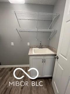 517 Dicks St, Lebanon, IN 46052 - washroom featuring a sink and dark wood-style floors