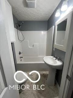 517 Dicks St, Lebanon, IN 46052 - bathroom featuring a sink, bathtub / shower combination, and a textured ceiling
