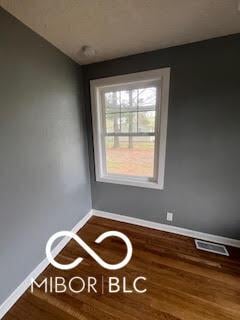 517 Dicks St, Lebanon, IN 46052 - spare room featuring visible vents, baseboards, and wood finished floors