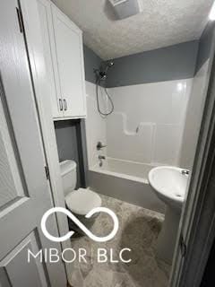 517 Dicks St, Lebanon, IN 46052 - bathroom featuring bathing tub / shower combination, a textured ceiling, and toilet