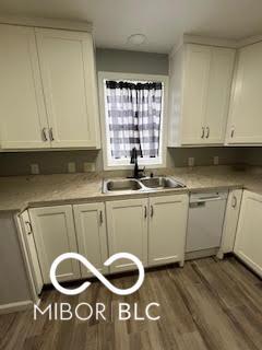 517 Dicks St, Lebanon, IN 46052 - kitchen featuring light countertops, white cabinetry, a sink, and wood finished floors
