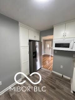 517 Dicks St, Lebanon, IN 46052 - kitchen with white microwave, stainless steel refrigerator with ice dispenser, baseboards, and dark wood finished floors