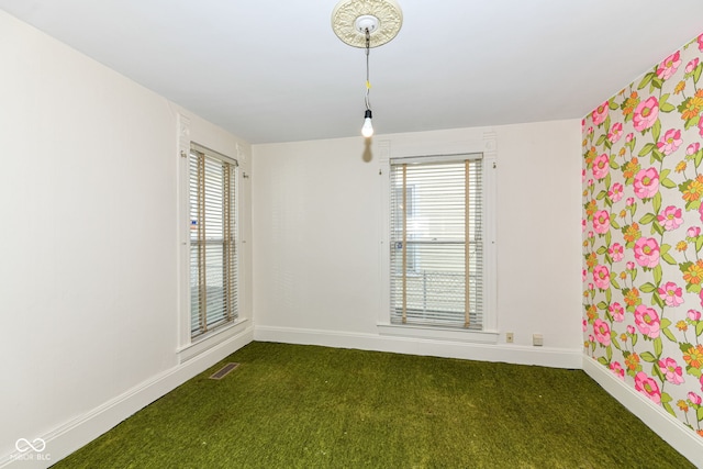 2001 S I St, Elwood, IN 46036 - unfurnished room featuring baseboards, a wealth of natural light, and carpet flooring