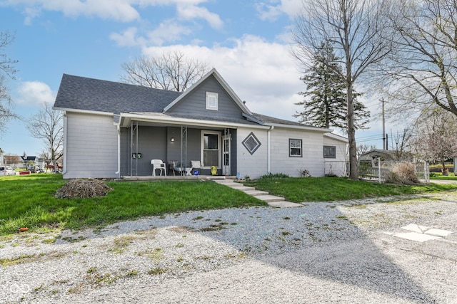 2001 S I St, Elwood, IN 46036 - view of front facade with roof with shingles, fence, a front yard, and covered porch
