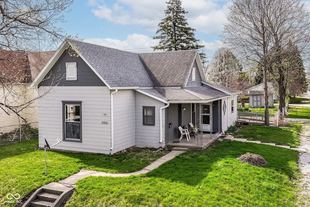 2001 S I St, Elwood, IN 46036 - back of property with a yard, roof with shingles, and a porch