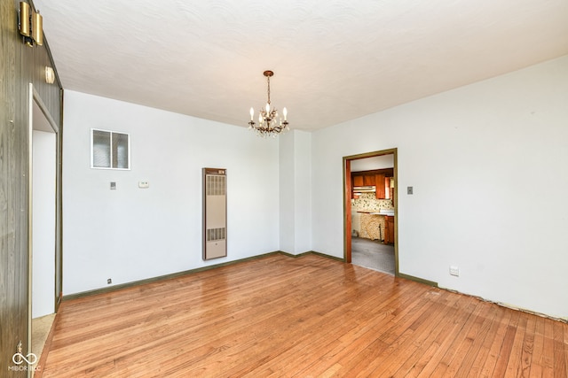 2001 S I St, Elwood, IN 46036 - empty room with a chandelier, visible vents, light wood finished floors, and baseboards