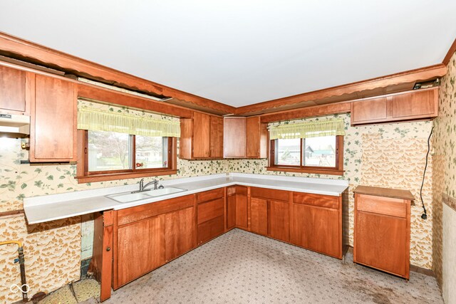 2001 S I St, Elwood, IN 46036 - kitchen with wallpapered walls, a sink, brown cabinetry, and a healthy amount of sunlight