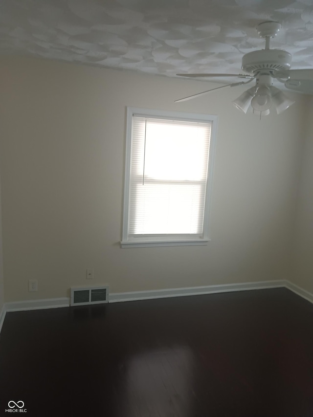 spare room featuring visible vents, baseboards, and a ceiling fan