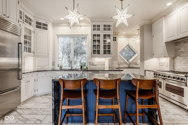 290 Breakwater Dr, Fishers, IN 46037 - kitchen featuring premium appliances, light marble finish flooring, tasteful backsplash, a center island, and dark stone counters