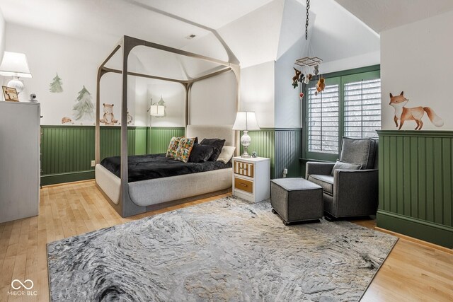 290 Breakwater Dr, Fishers, IN 46037 - bedroom featuring a wainscoted wall, vaulted ceiling, and wood finished floors