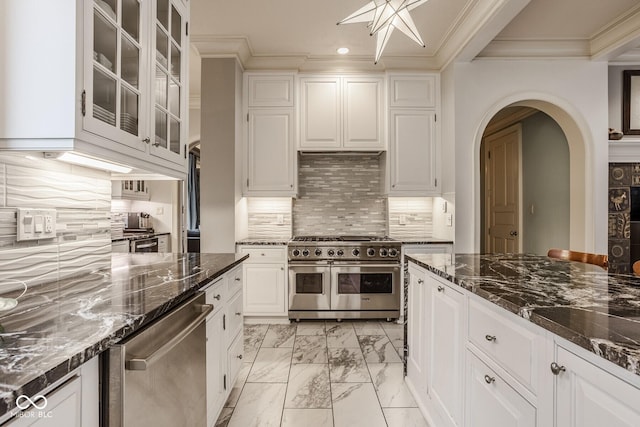 290 Breakwater Dr, Fishers, IN 46037 - kitchen with stainless steel appliances, light marble finish floors, crown molding, recessed lighting, and dark stone countertops