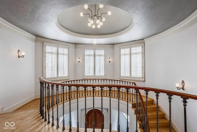 290 Breakwater Dr, Fishers, IN 46037 - staircase featuring a chandelier, wood finished floors, baseboards, and a tray ceiling
