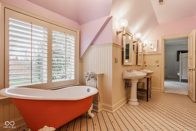 290 Breakwater Dr, Fishers, IN 46037 - full bath with vaulted ceiling, a soaking tub, and a wainscoted wall