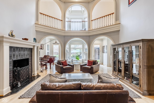 290 Breakwater Dr, Fishers, IN 46037 - living room with arched walkways, a fireplace, and a towering ceiling