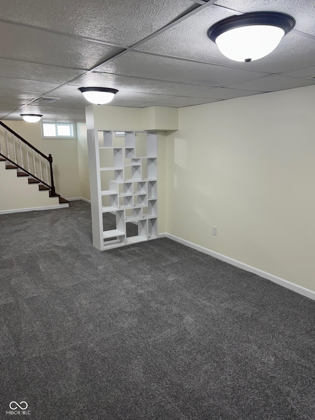 basement with carpet floors, baseboards, and stairs