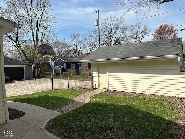 view of yard featuring an outdoor structure and fence