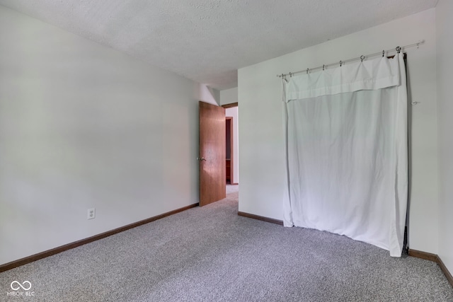 8160 Bold Forbes Ct, Indianapolis, IN 46217 - unfurnished bedroom featuring carpet flooring and a textured ceiling