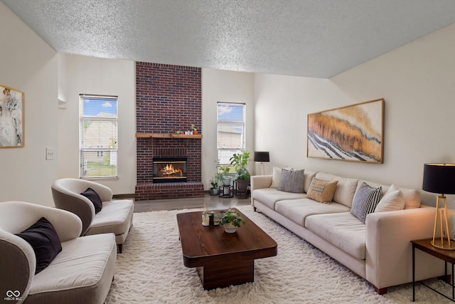 living area featuring a textured ceiling and a fireplace
