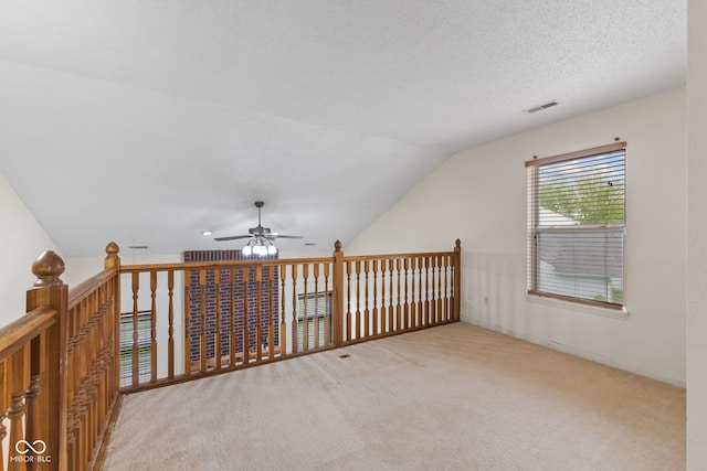 additional living space with ceiling fan, carpet, vaulted ceiling, and visible vents