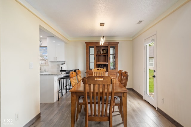 dining room with visible vents, a wealth of natural light, and light wood-style floors