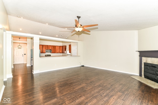 6479 Enclave Blvd, Greenwood, IN 46143 - unfurnished living room with a ceiling fan, dark wood-style flooring, a tile fireplace, baseboards, and recessed lighting