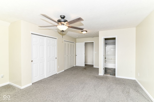 6479 Enclave Blvd, Greenwood, IN 46143 - unfurnished bedroom featuring carpet flooring, baseboards, and multiple closets