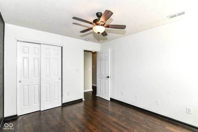 6479 Enclave Blvd, Greenwood, IN 46143 - unfurnished bedroom featuring dark wood-style flooring, a closet, a ceiling fan, baseboards, and a textured ceiling