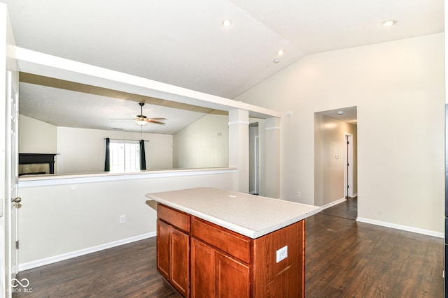6479 Enclave Blvd, Greenwood, IN 46143 - kitchen with lofted ceiling, dark wood-type flooring, a ceiling fan, a kitchen island, and light countertops
