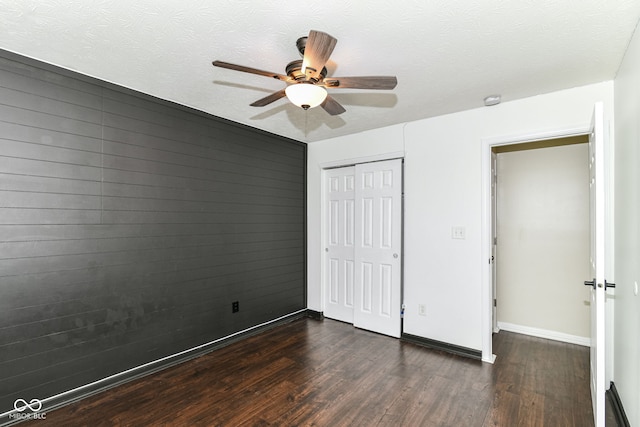 6479 Enclave Blvd, Greenwood, IN 46143 - unfurnished bedroom with dark wood finished floors, baseboards, a closet, and ceiling fan